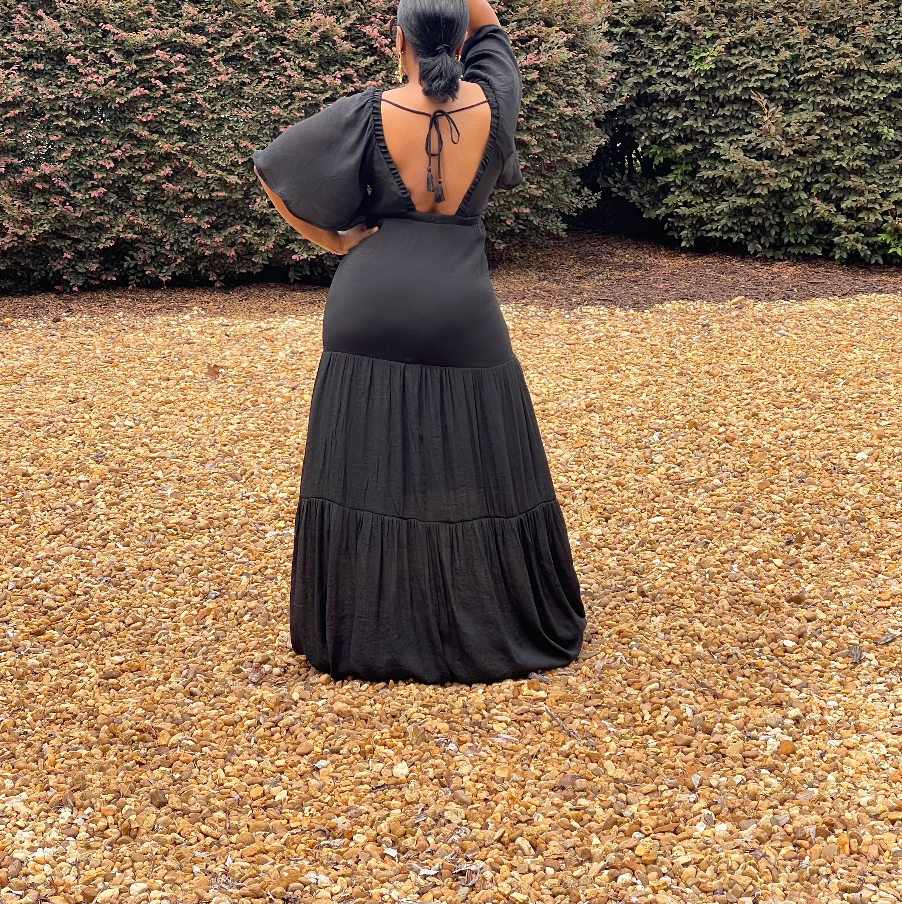 GOLDxTEAL black plunging neckline maxi dress with flowy elbow length sleeves.