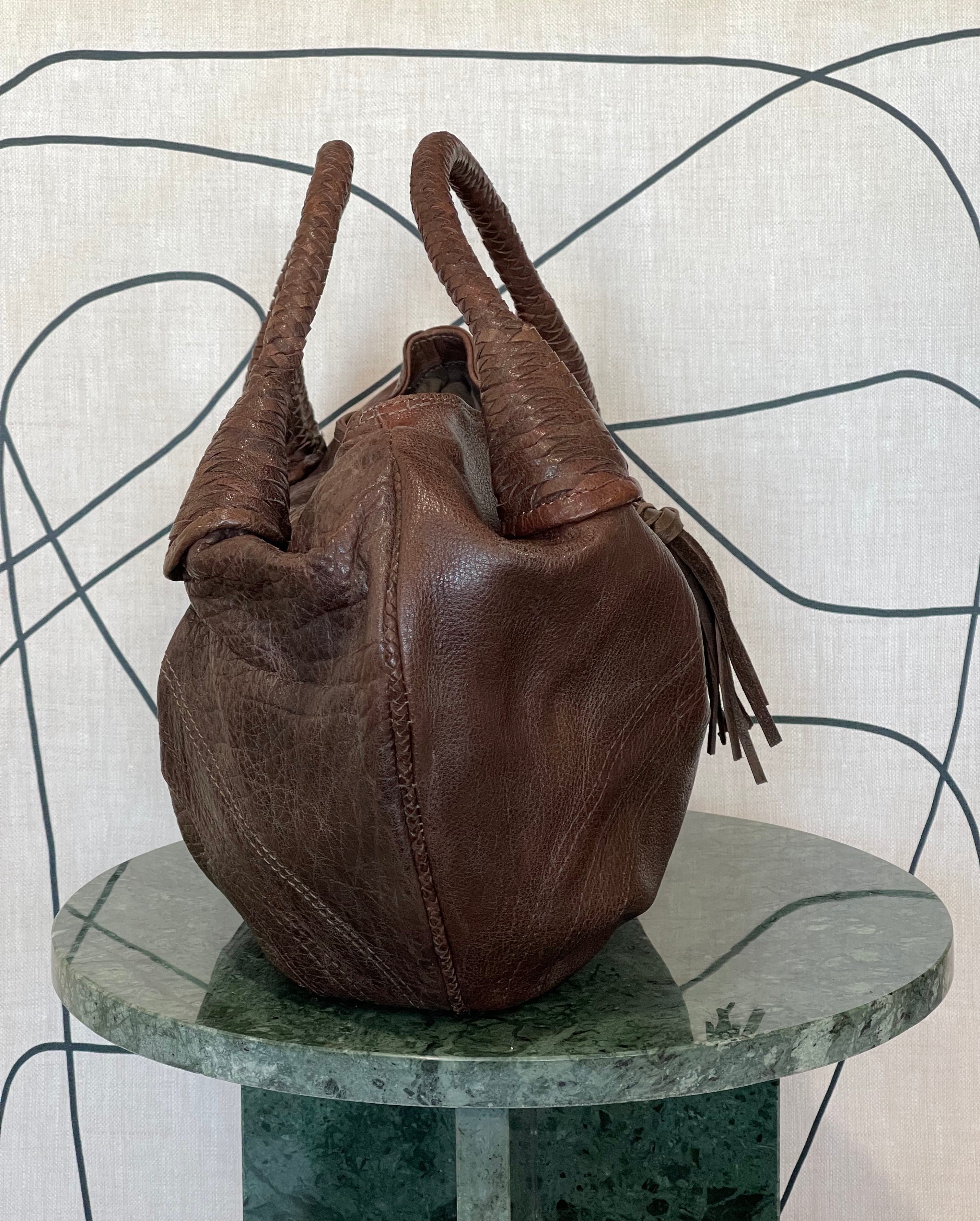 Side view of Mousse Hobo Handbag by GOLD x TEAL showing soft sculpted leather silhouette and woven lattice piping detail, texture.