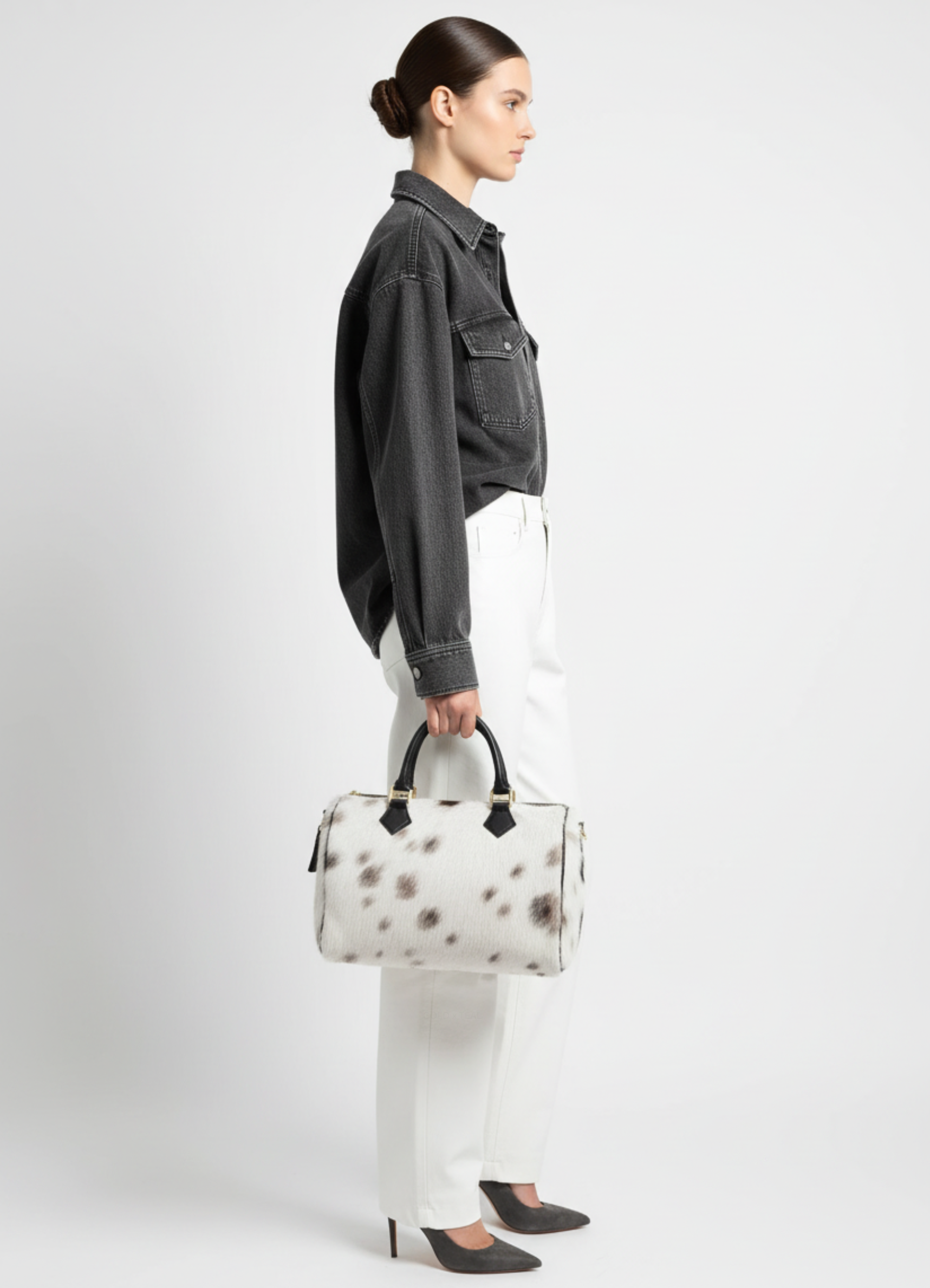 Atlas calf hair bag carried by model showing scale and structured silhouette.