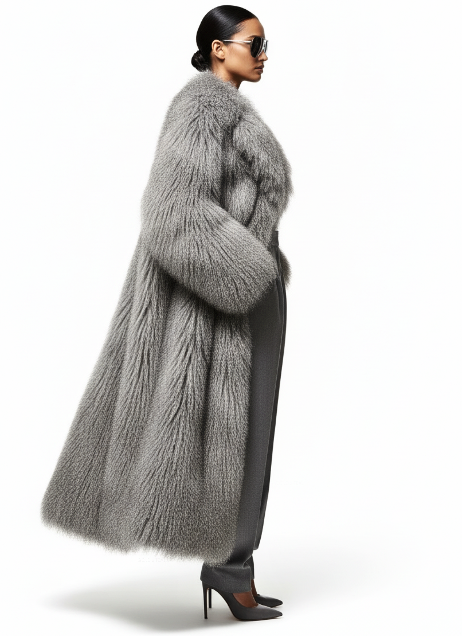 Side view of model wearing the GOLD x TEAL Aurelia Fur Coat in gray, showcasing rich textured fur and full-length design.