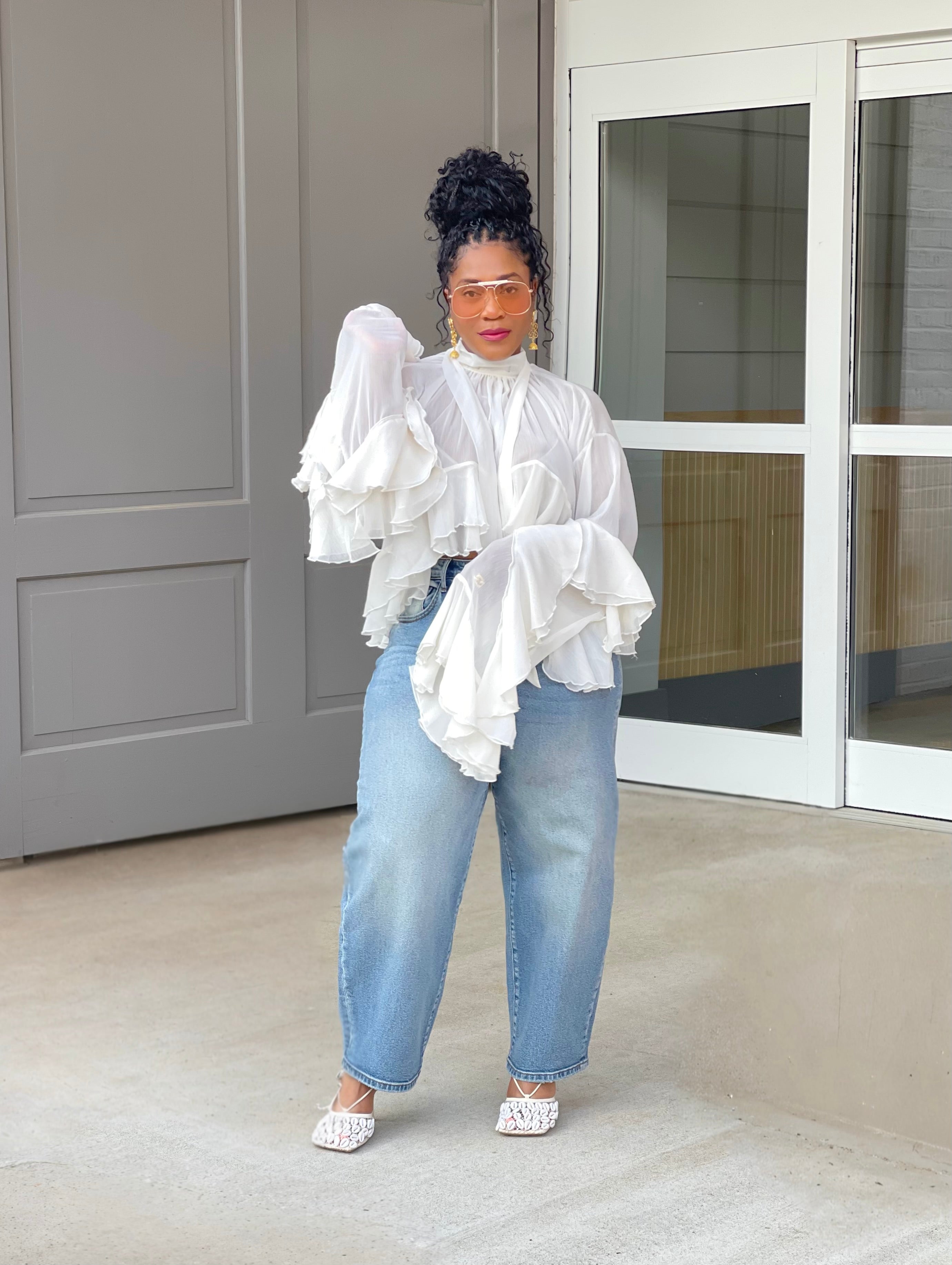 Model wearing a gorgeous GOLDxTEAL cascading ruffle top with dramatic romantic sleeves.
