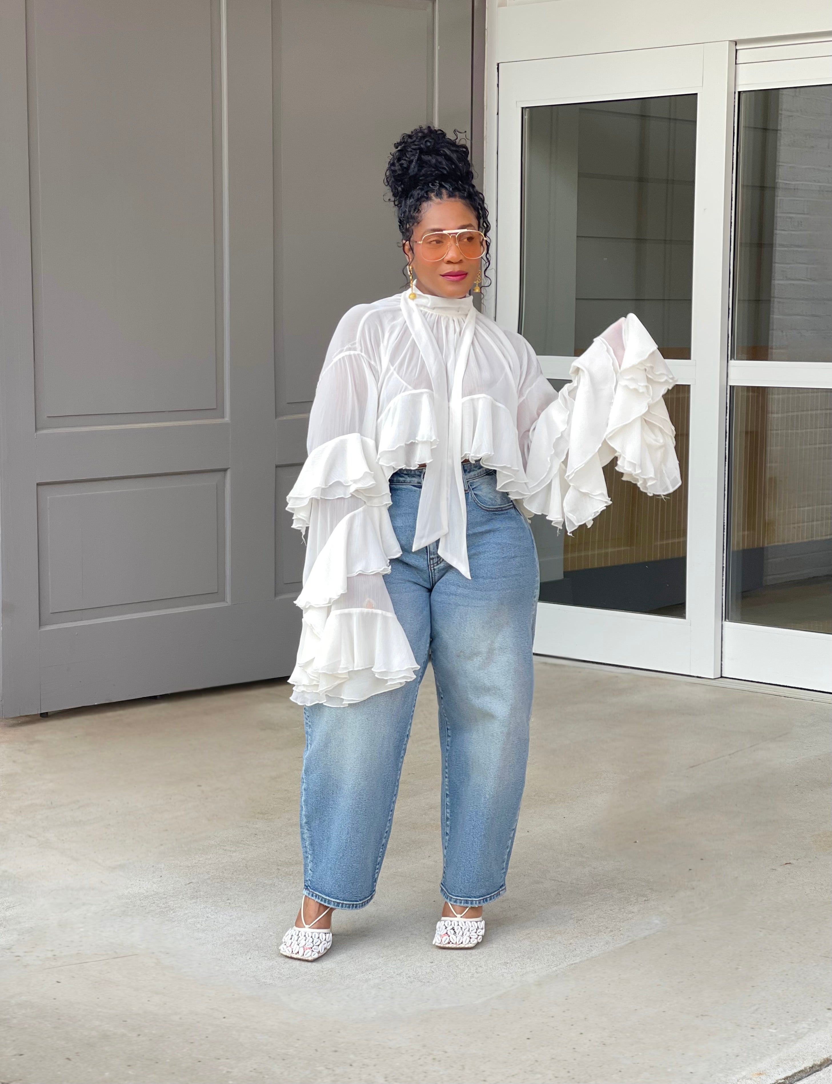 Model wearing a gorgeous GOLDxTEAL cascading ruffle top with dramatic romantic sleeves.