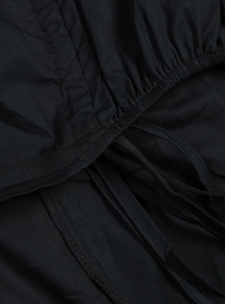 GOLDxTEAL black ruched mini dress.