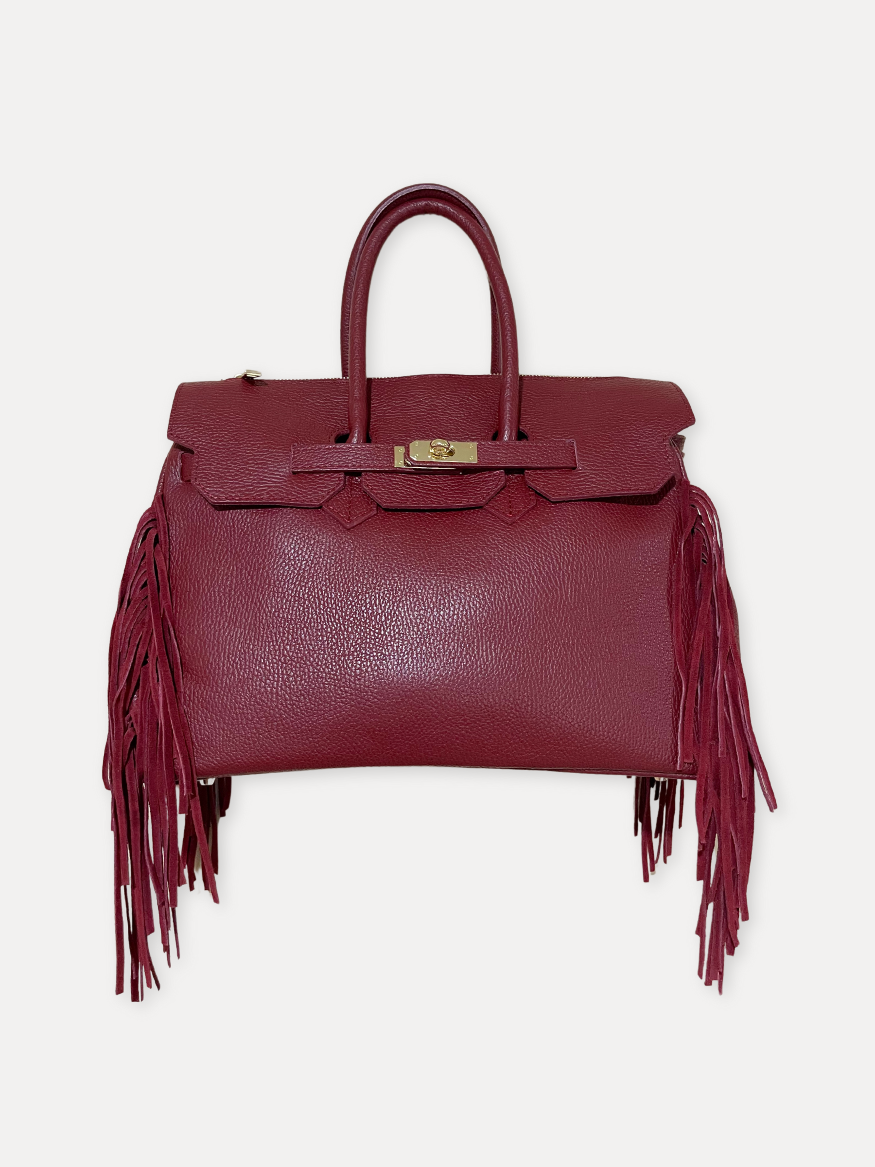 GOLDxTEAL gorgeous timeless pebbled grained leather satchel with fringe in the color Bordeaux.