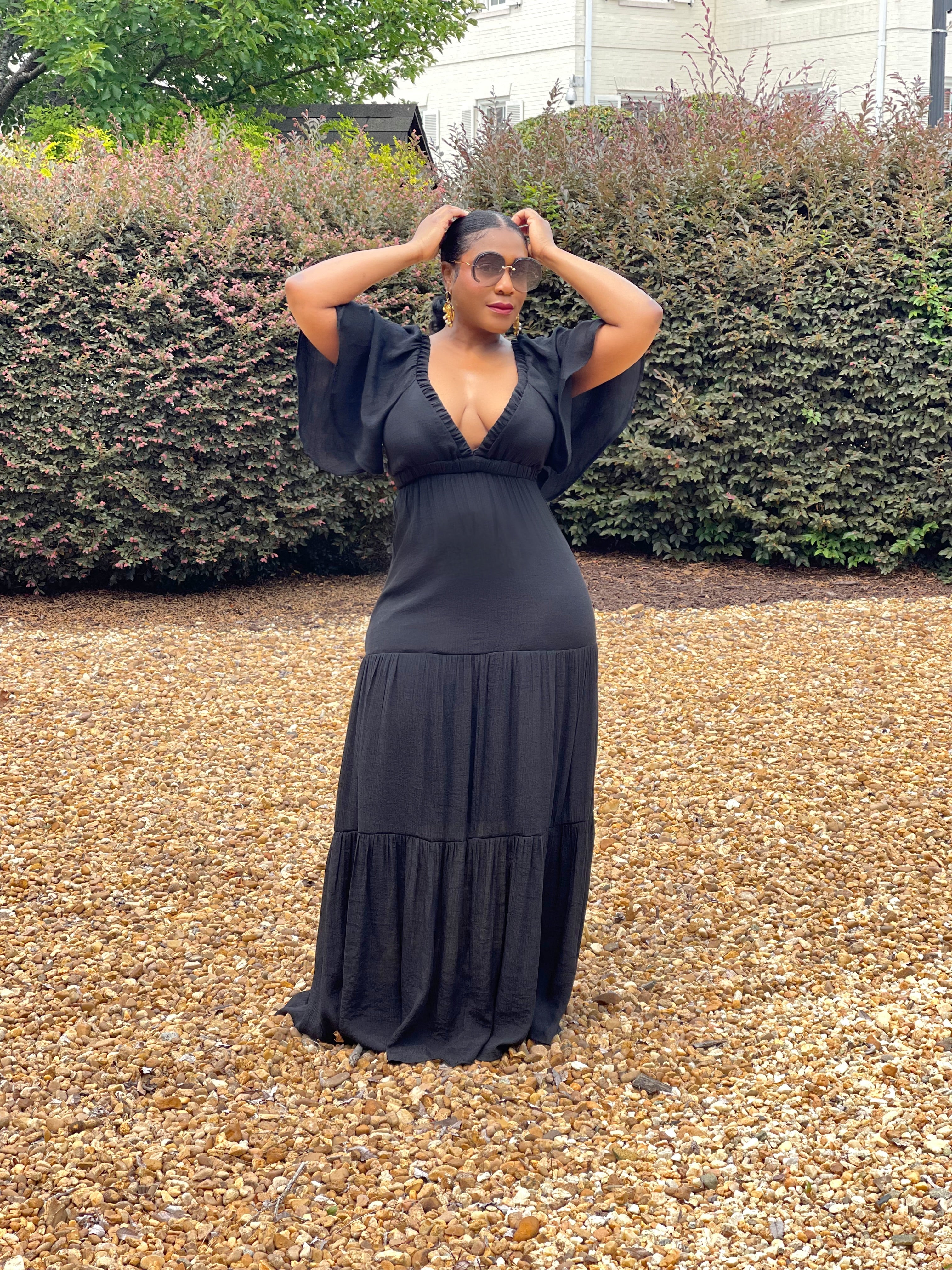 GOLDxTEAL black plunging neckline maxi dress with flowy elbow length sleeves.