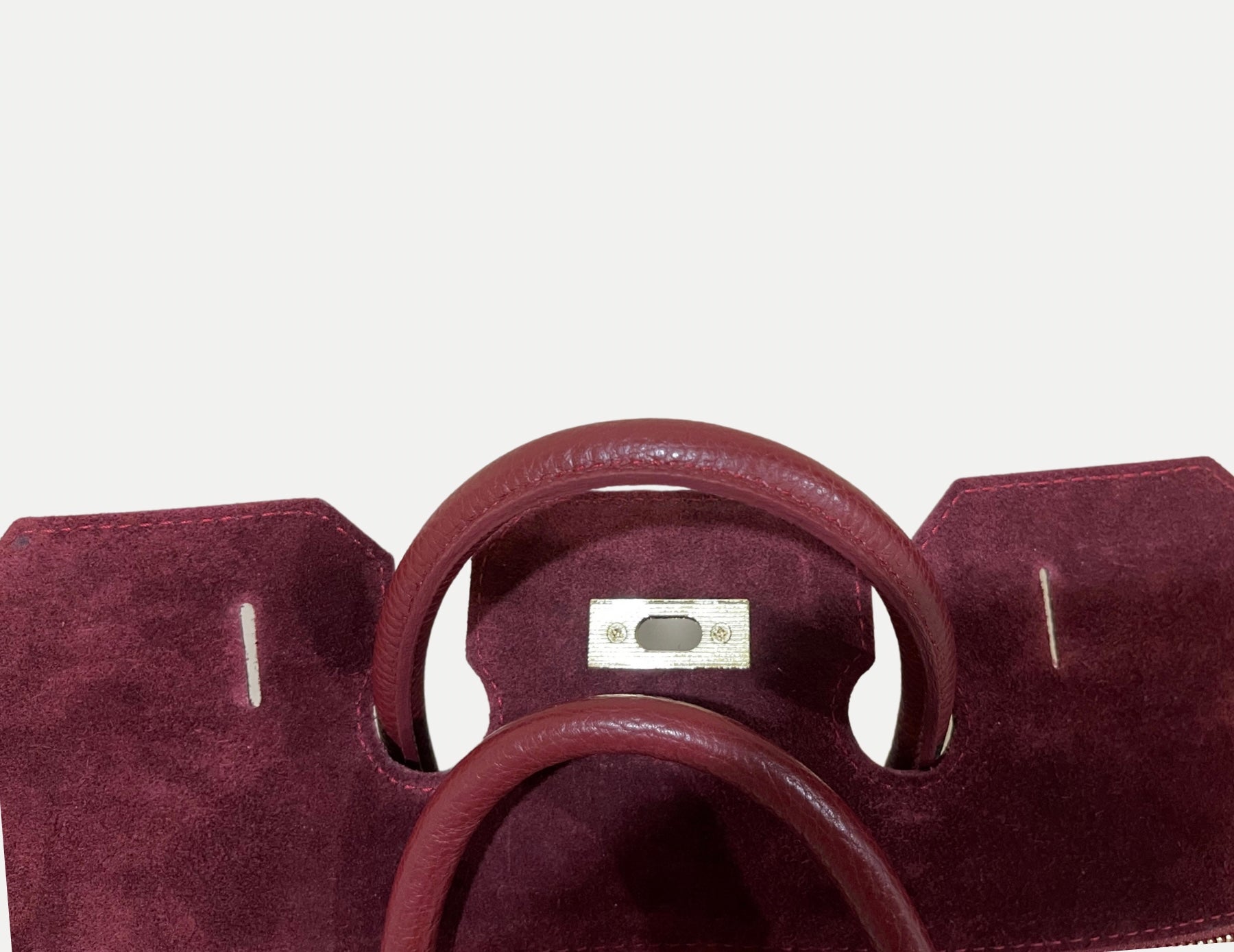 GOLDxTEAL gorgeous timeless pebbled grained leather satchel with fringe in the color Bordeaux.