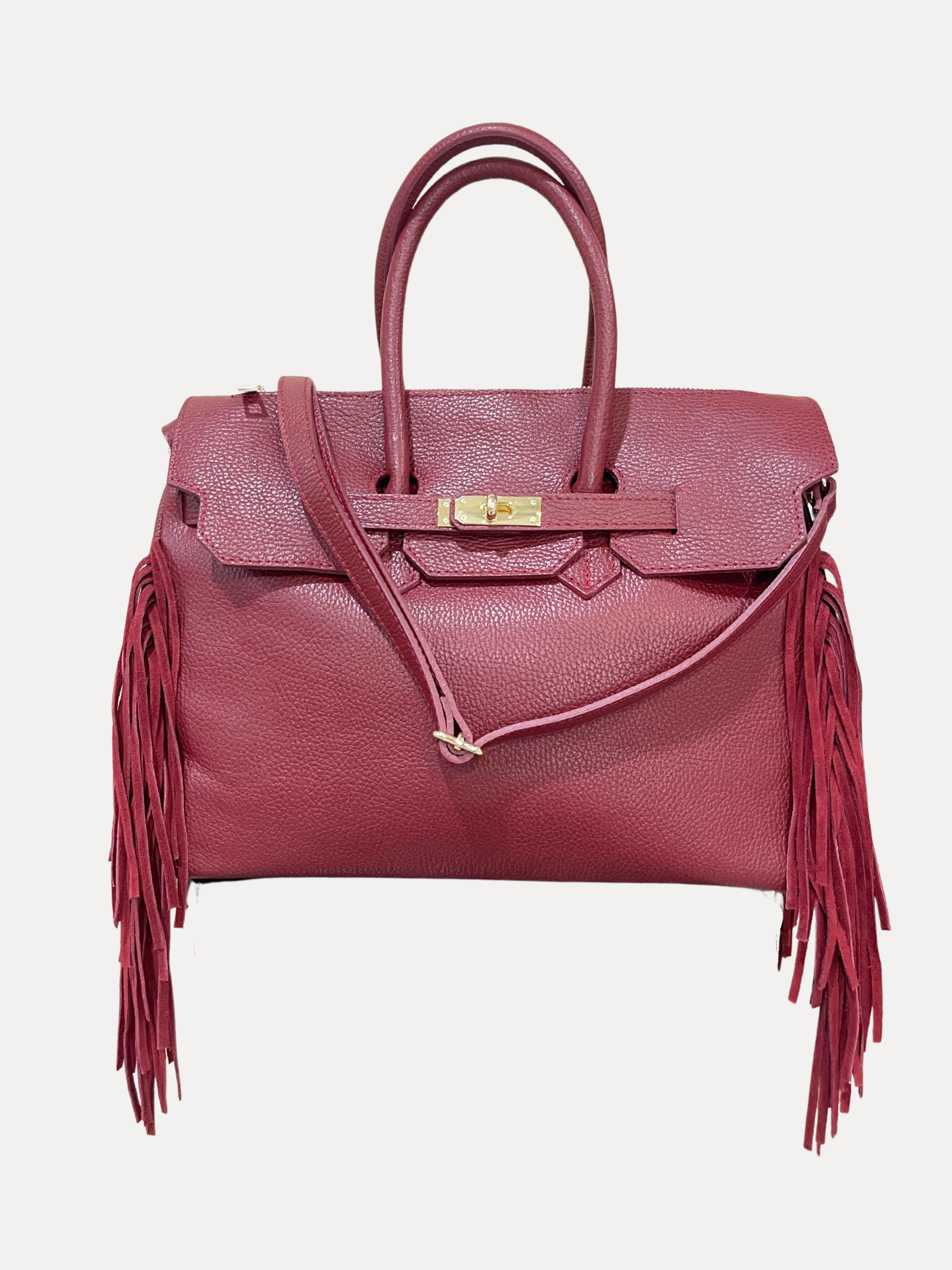 GOLDxTEAL gorgeous timeless pebbled grained leather satchel with fringe in the color Bordeaux.
