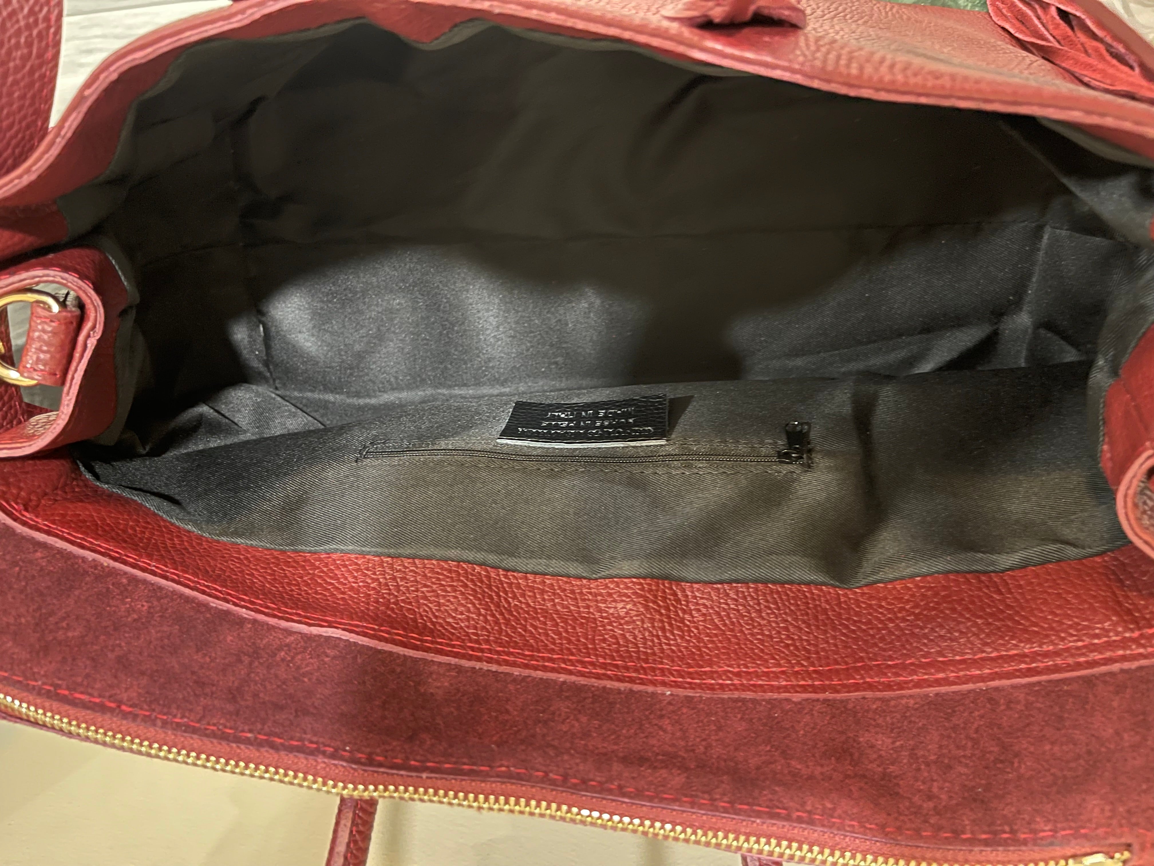 GOLDxTEAL gorgeous timeless pebbled grained leather satchel with fringe in the color Bordeaux.