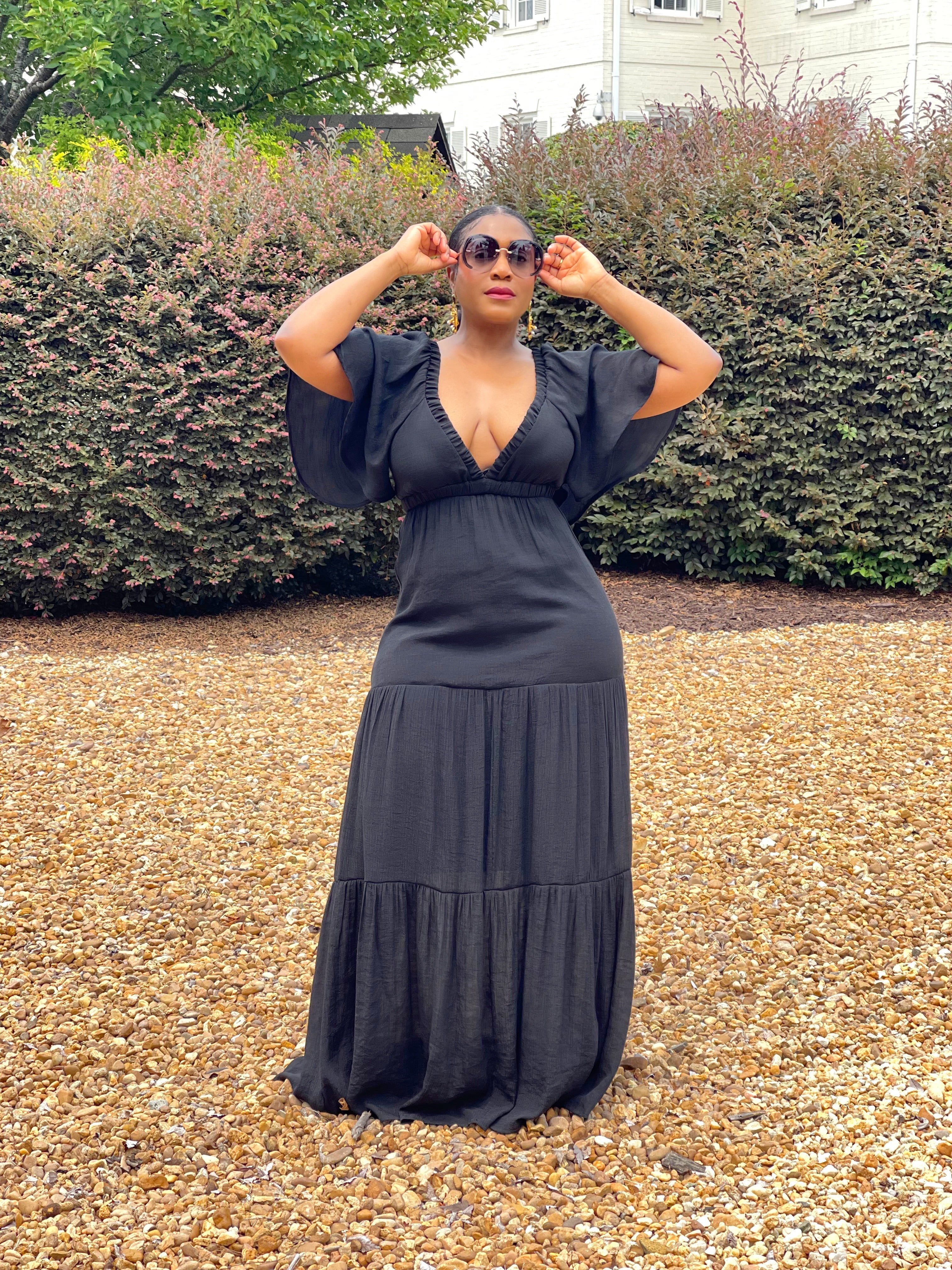 GOLDxTEAL black plunging neckline maxi dress with flowy elbow length sleeves.