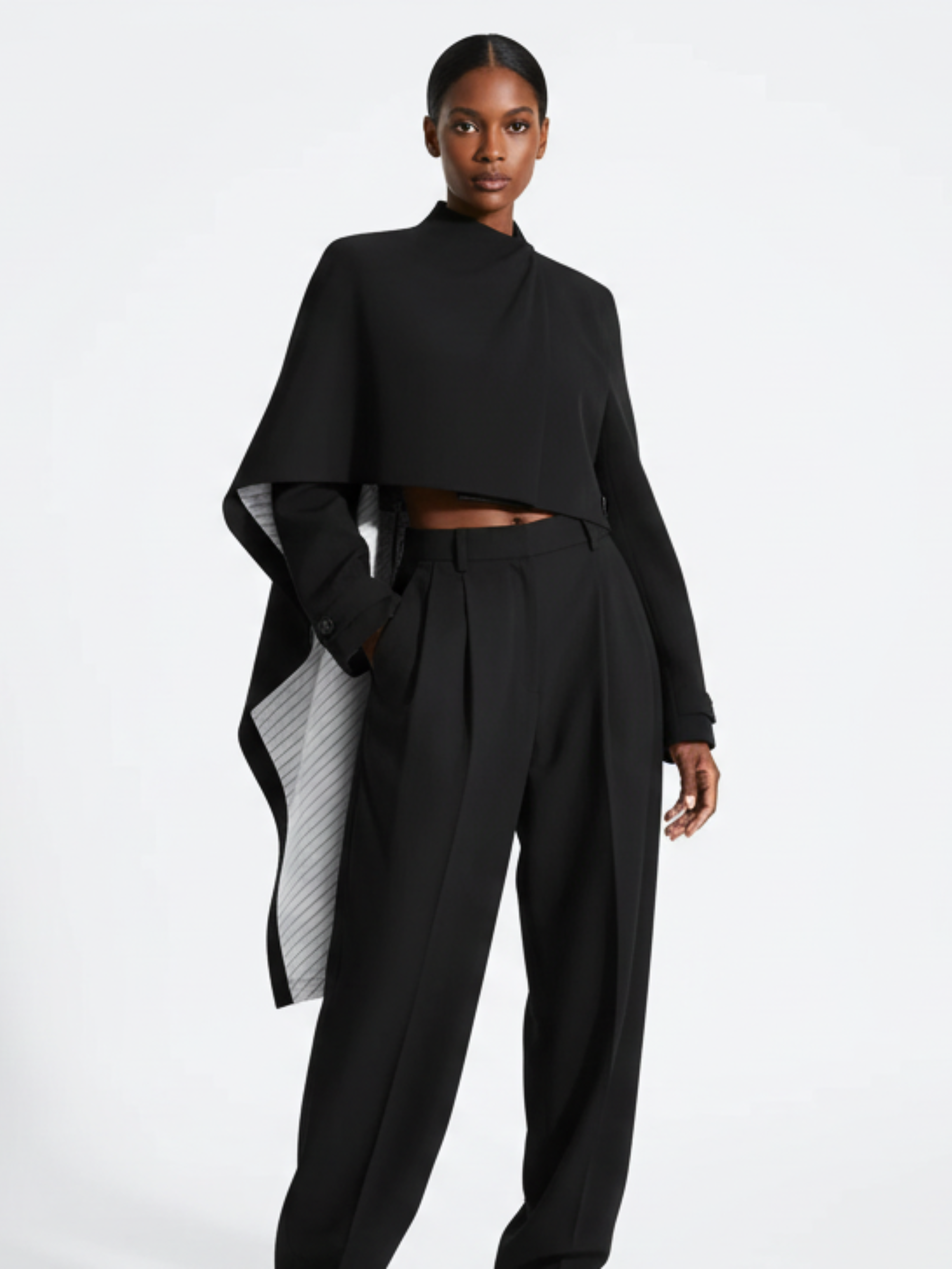 Astra Crop Cape Jacket in black by GOLD x TEAL, asymmetrical cropped cape silhouette.