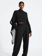 Astra Crop Cape Jacket in black by GOLD x TEAL, asymmetrical cropped cape silhouette.