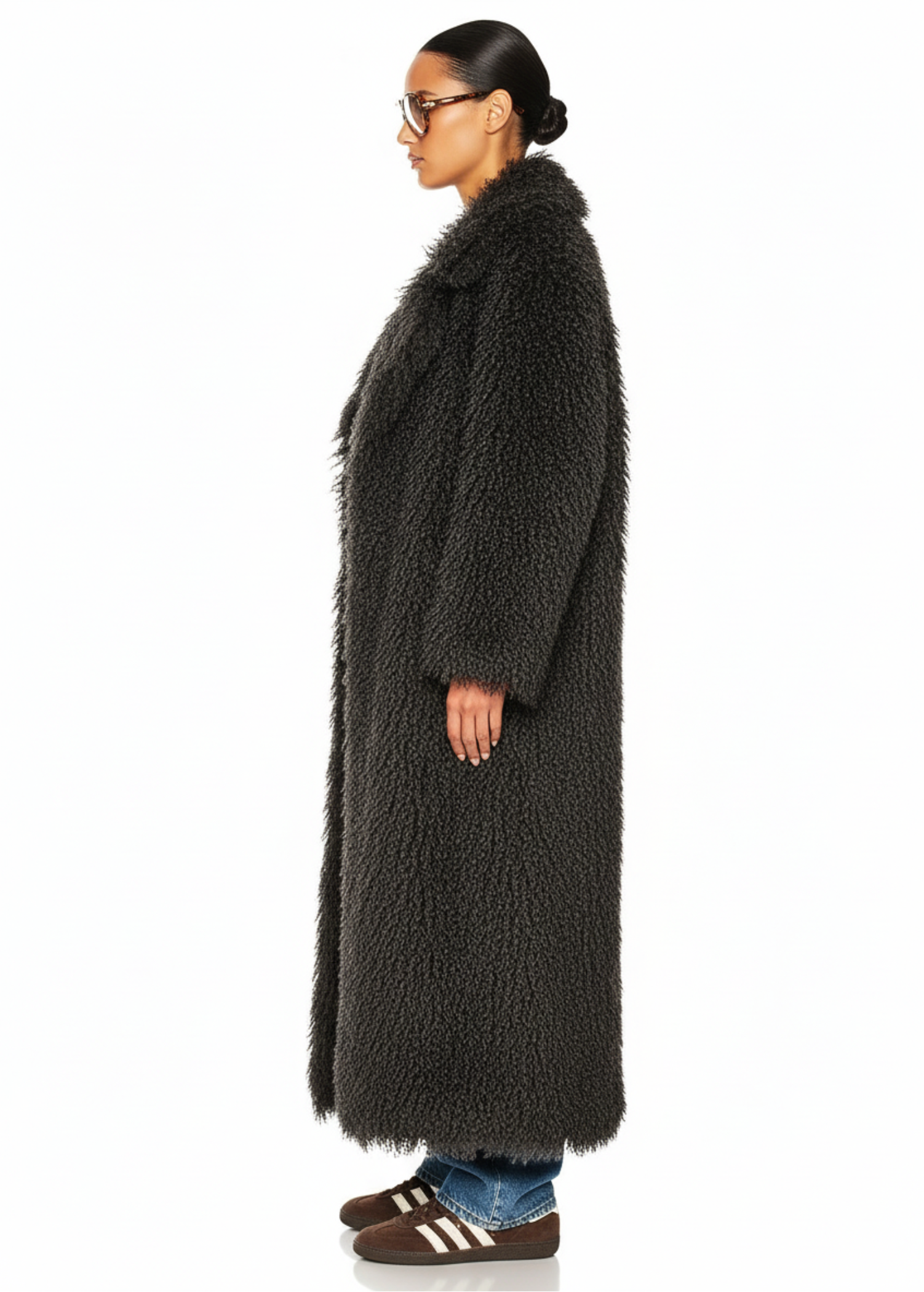 Side profile of the GOLD x TEAL Mocha Opulence Coat showing plush mocha faux Mongolian fur and long silhouette.