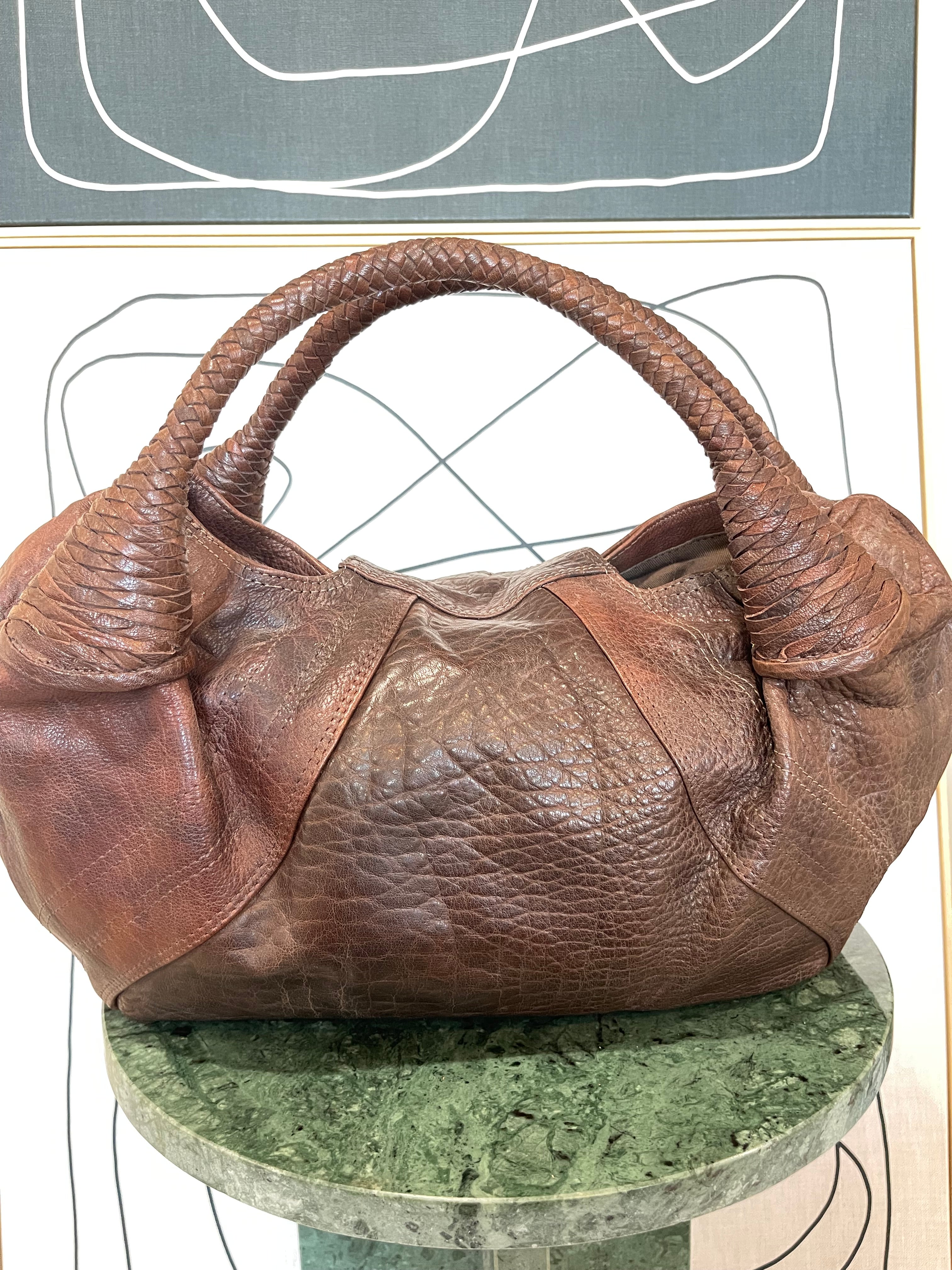 Back view of Mousse Hobo Handbag by GOLD x TEAL featuring smooth pebbled leather construction and curved hobo silhouette.