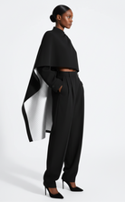 Astra Crop Cape Jacket side view in black, wide sleeve detail, GOLD x TEAL.