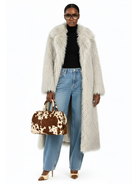 Front view of the GOLD x TEAL Frost Luxe Coat styled with jeans and a cowhide handbag, showcasing long faux Mongolian fur texture and elegant lapel collar.