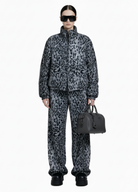 Model wearing the Savanna Off-Duty Set with relaxed fit zip jacket and elastic waist wide-leg pants from GOLD x TEAL.