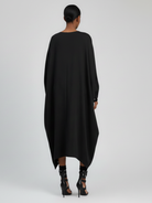 Back view of oversized cocoon dress with flowing silhouette.