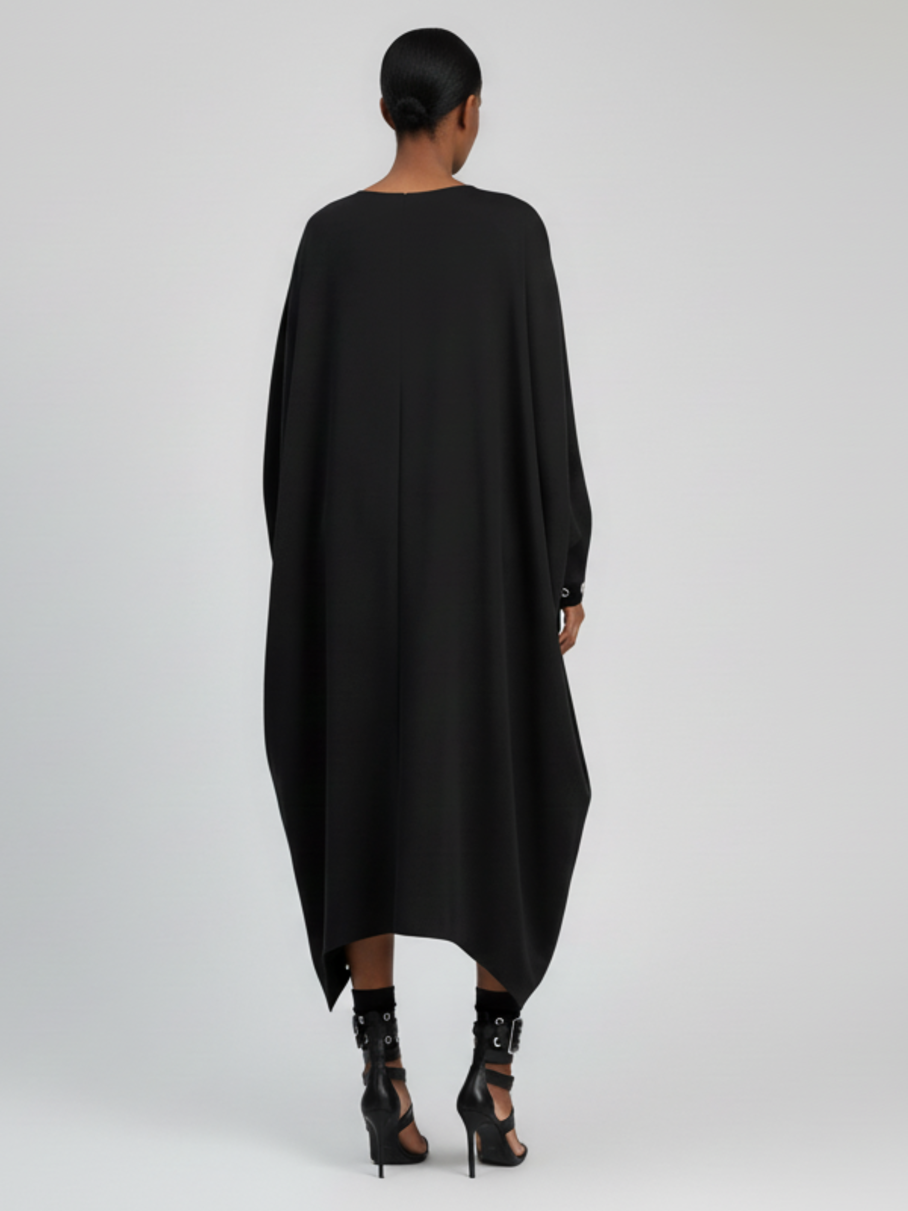 Back view of oversized cocoon dress with flowing silhouette.