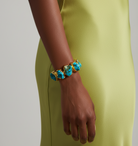 Raw turquoise stone bracelet with gold-plated brass trim by GOLD x TEAL on model.
