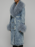 Side view of the Azure Shearling Denim Trench showcasing the oversized Mongolian fur collar, sleeve trim, and structured denim silhouette.