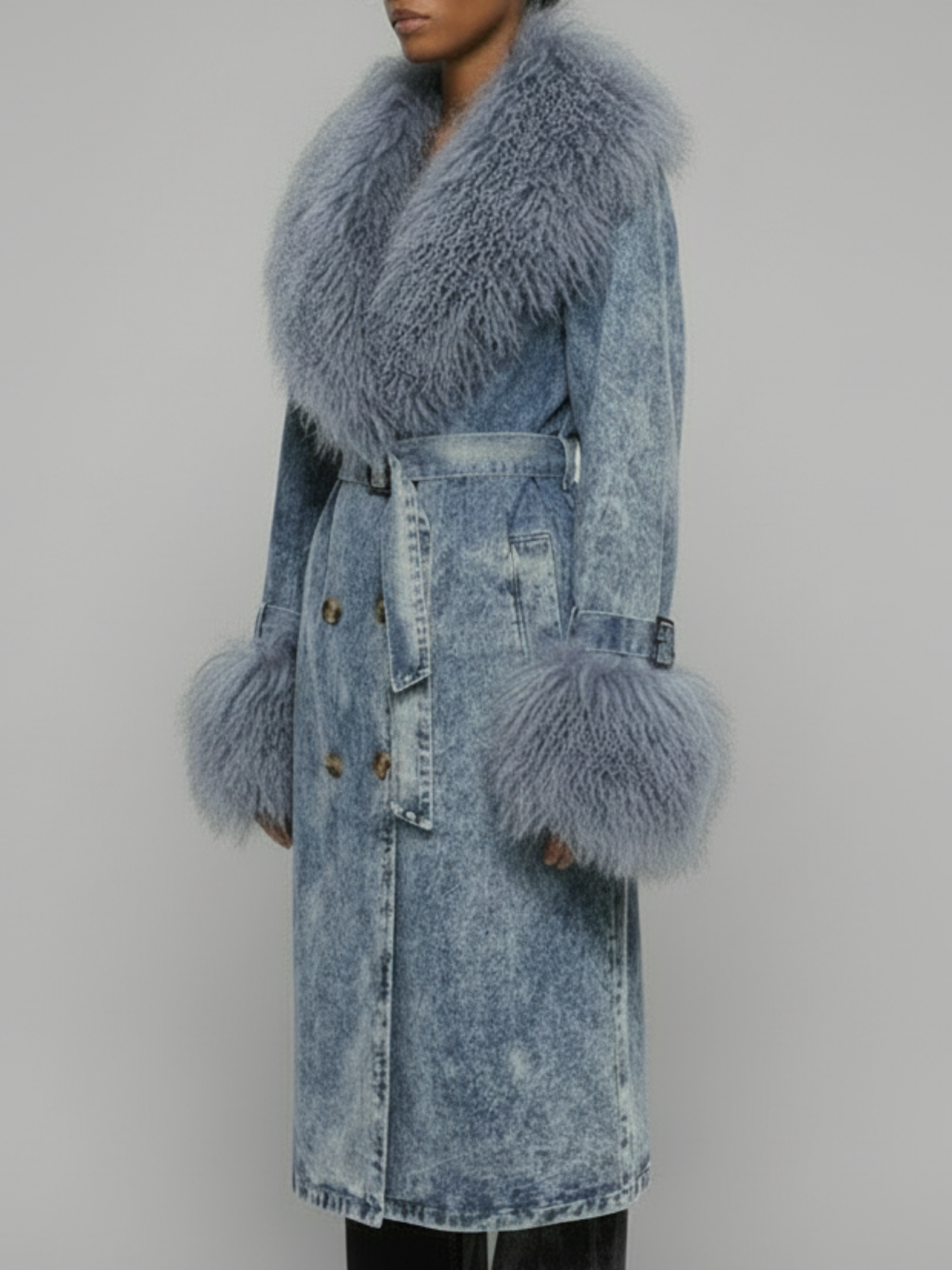 Side view of the Azure Shearling Denim Trench showcasing the oversized Mongolian fur collar, sleeve trim, and structured denim silhouette.