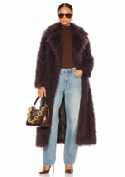 GOLDxTEAL front view of the Bordeaux Opulence Coat in deep Bordeaux faux Mongolian fur with chic lapel collar, model styling hand in pocket.