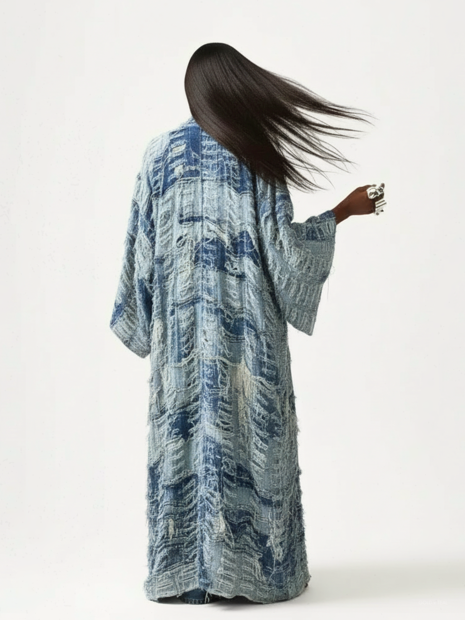 Back view of model with long hair sweeping to the side in motion.
