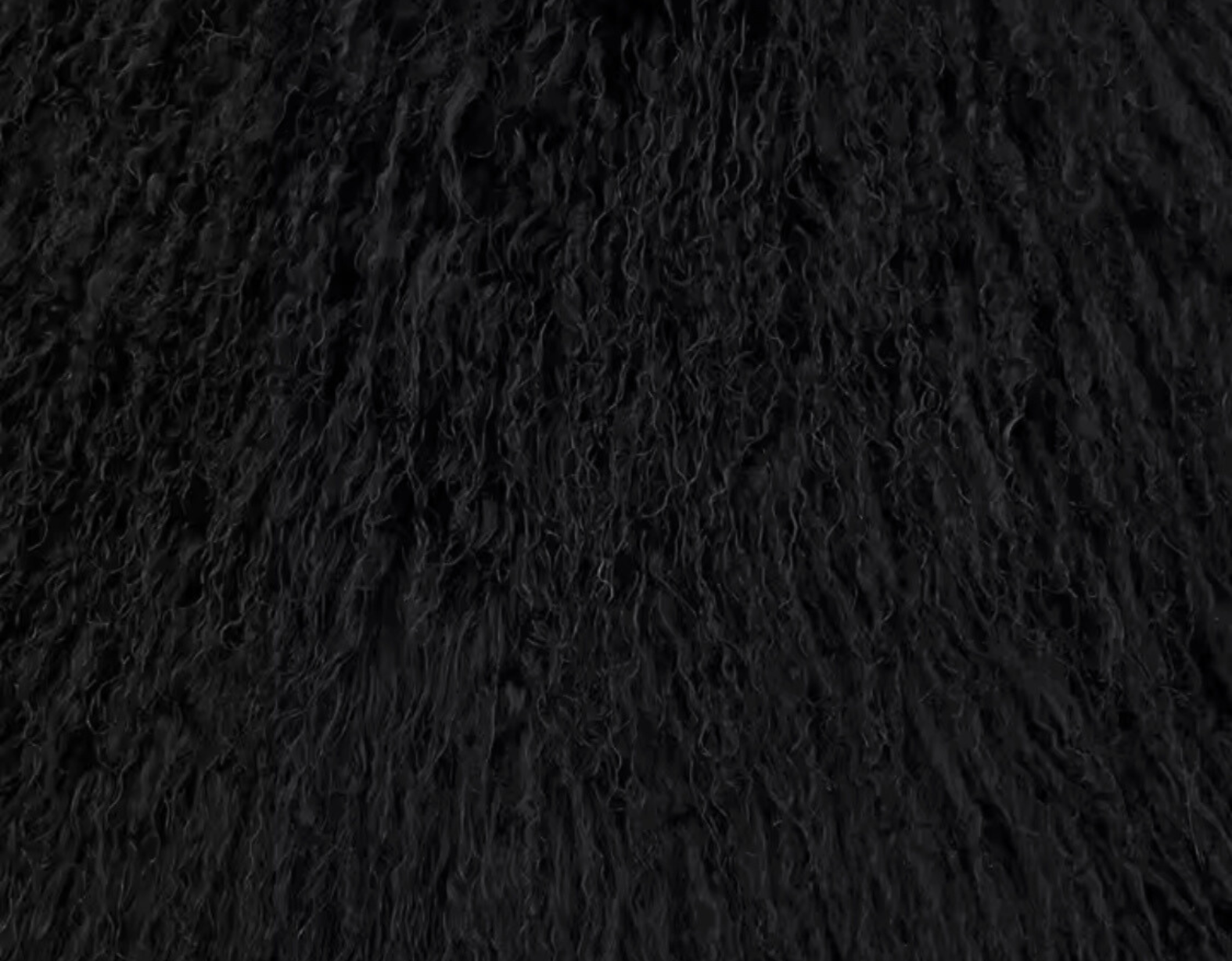 Close-up detail of black Mongolian fur texture on the GOLD x TEAL Nomad Fur Scarf Vest highlighting depth, curl, and natural variation.