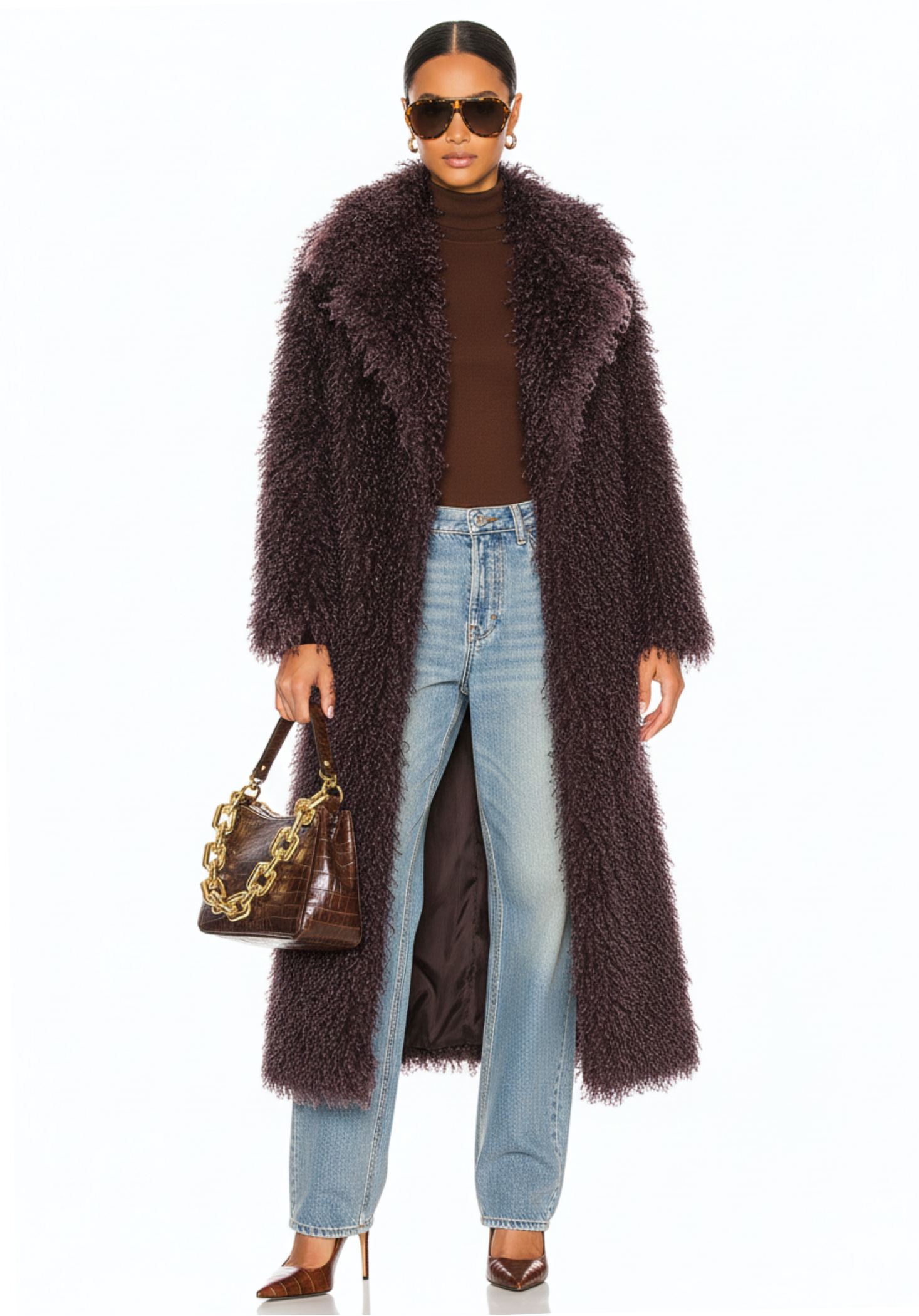 GOLDxTEAL model wearing the Bordeaux Opulence Coat in faux Mongolian fur, full-length front view, styled with jeans and a handbag.