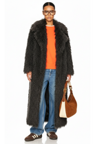 Model styled in the GOLD x TEAL Mocha Opulence Coat with casual denim and orange sweater, front view.