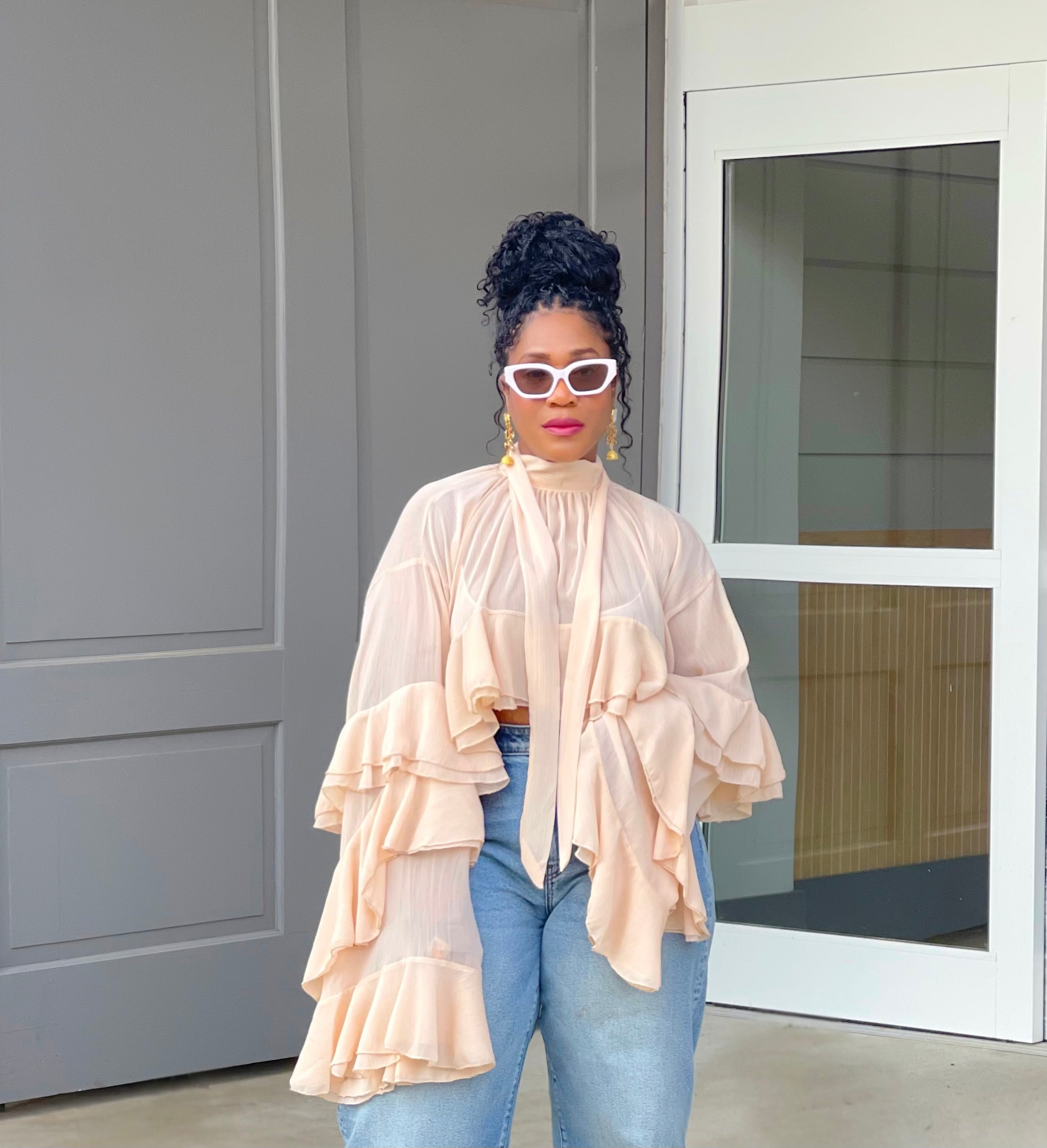 Model wearing a gorgeous GOLDxTEAL cascading ruffle top with dramatic romantic sleeves.