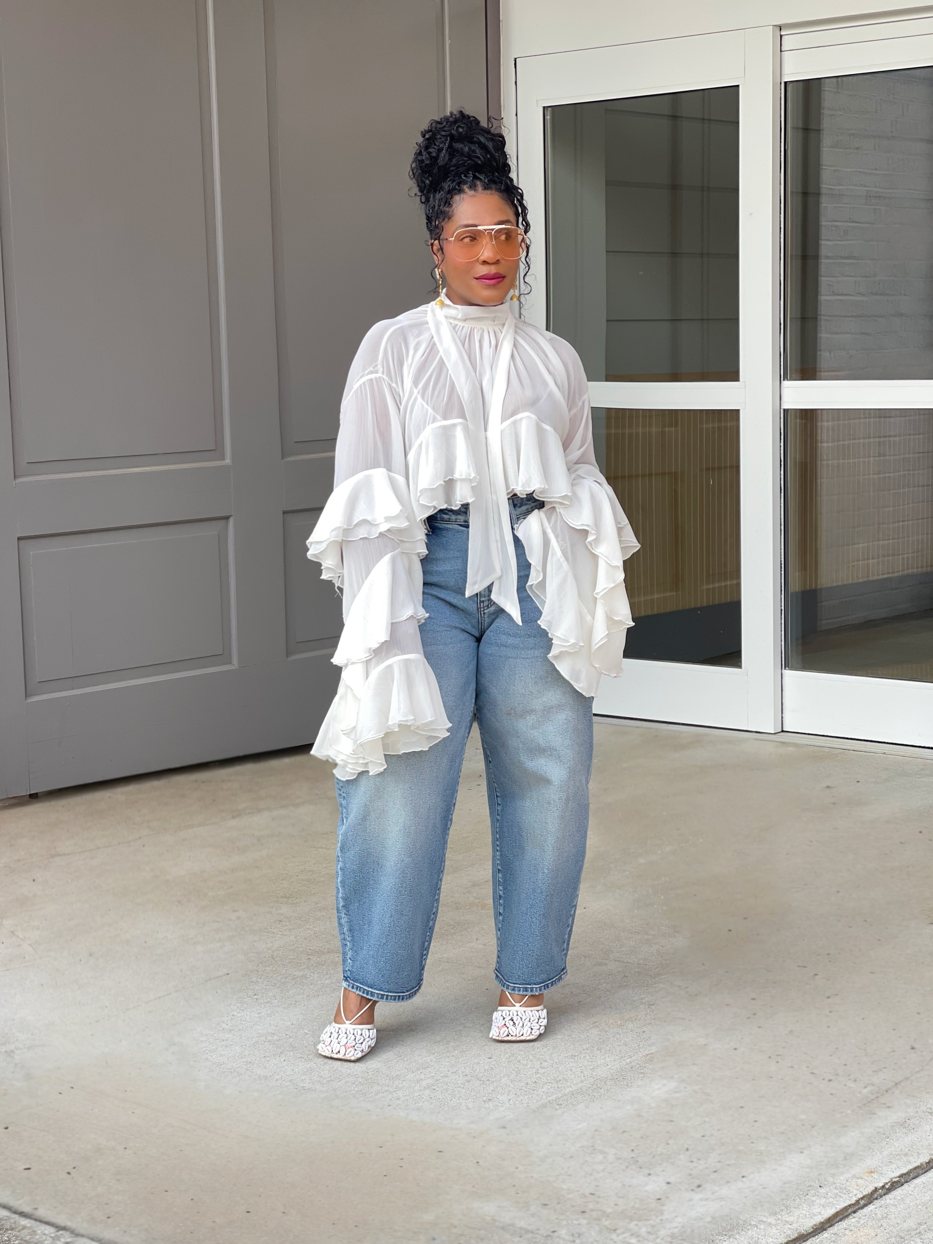 Model wearing a gorgeous GOLDxTEAL cascading ruffle top with dramatic romantic sleeves.