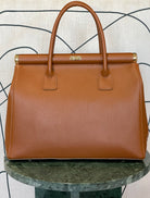 GOLDxTEAL gorgeous amber leather color handbag with gold metal lock.