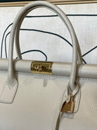 GOLDxTEAL gorgeous ecru leather handbag with gold lock detail.