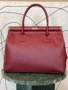 GOLD xTEAL chic Bordeaux leather lock handbag.