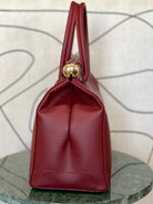 GOLD xTEAL chic Bordeaux leather lock handbag.