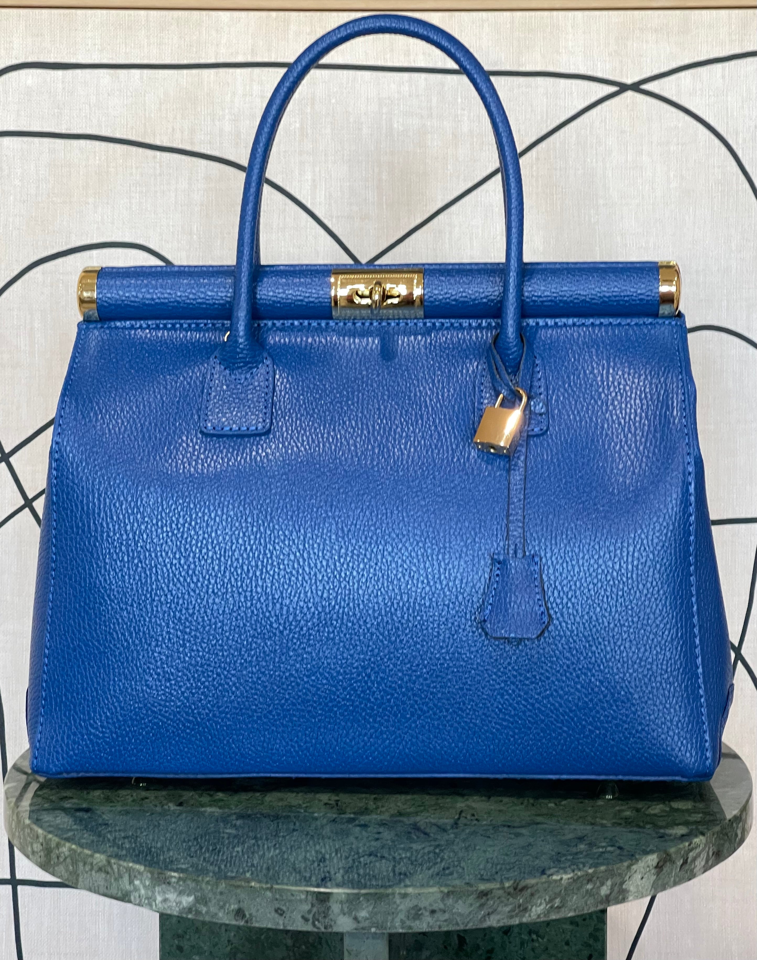 GOLDxTEAL gorgeous blue electric leather handbag with gold tone metal lock.