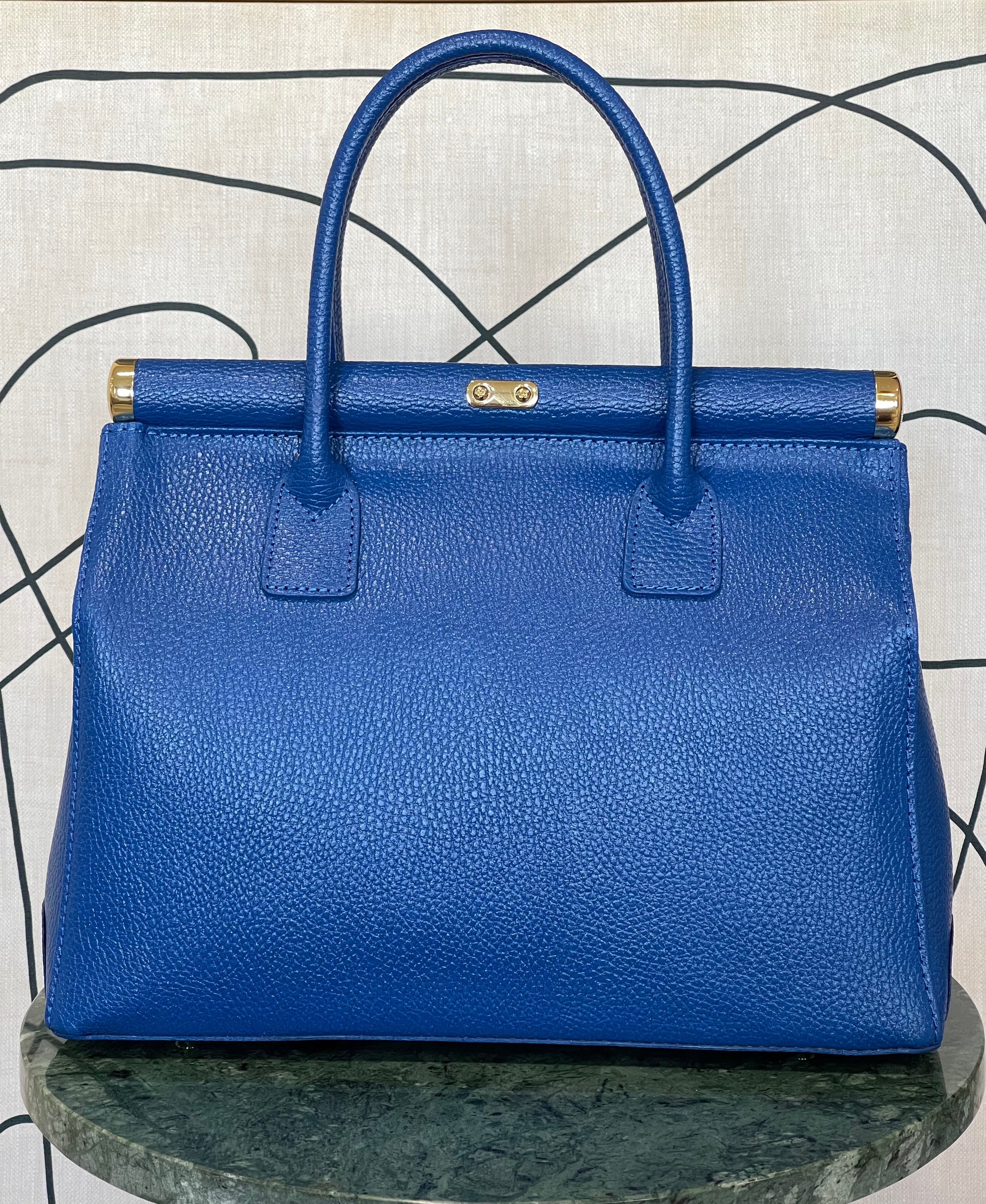 GOLDxTEAL gorgeous blue electric leather handbag with gold tone metal lock.