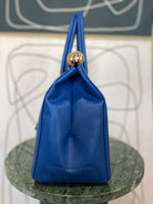 GOLDxTEAL gorgeous blue electric leather handbag with gold tone metal lock.