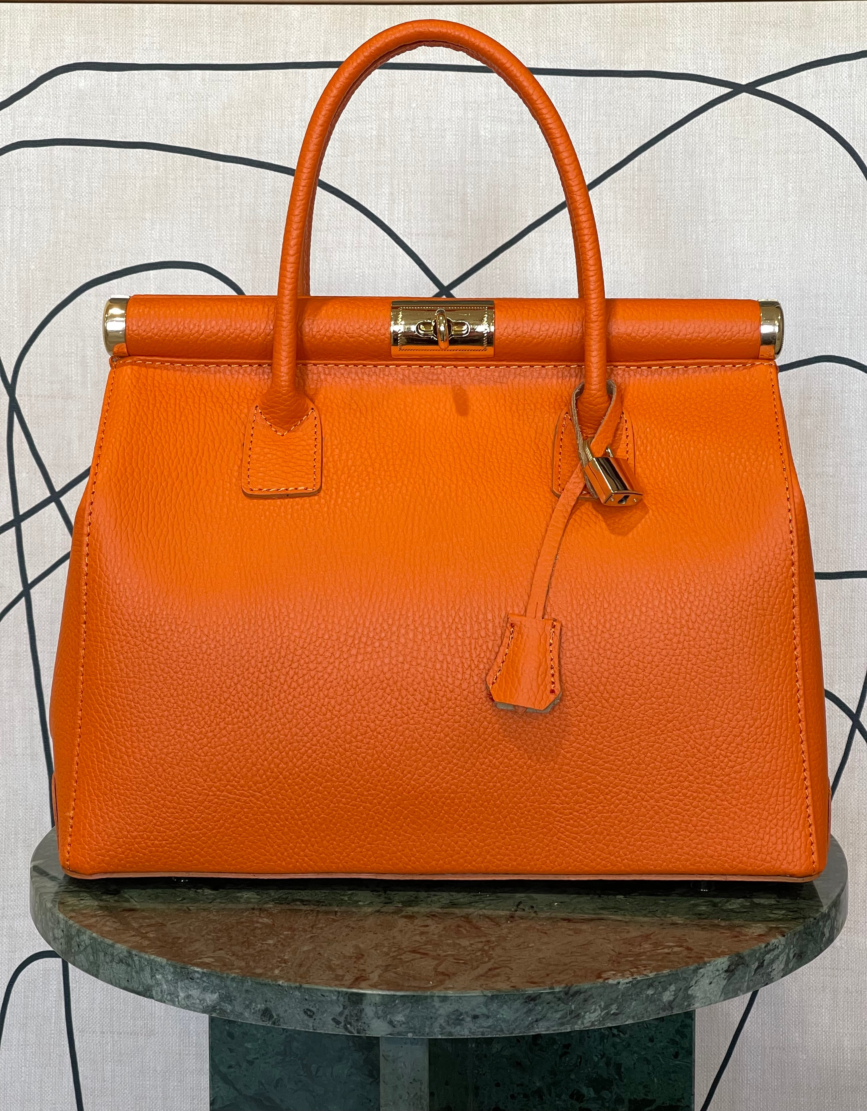 GOLDxTEAL gorgeous orange leather gold metal lock handbag.