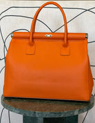 GOLDxTEAL gorgeous orange leather gold metal lock handbag.