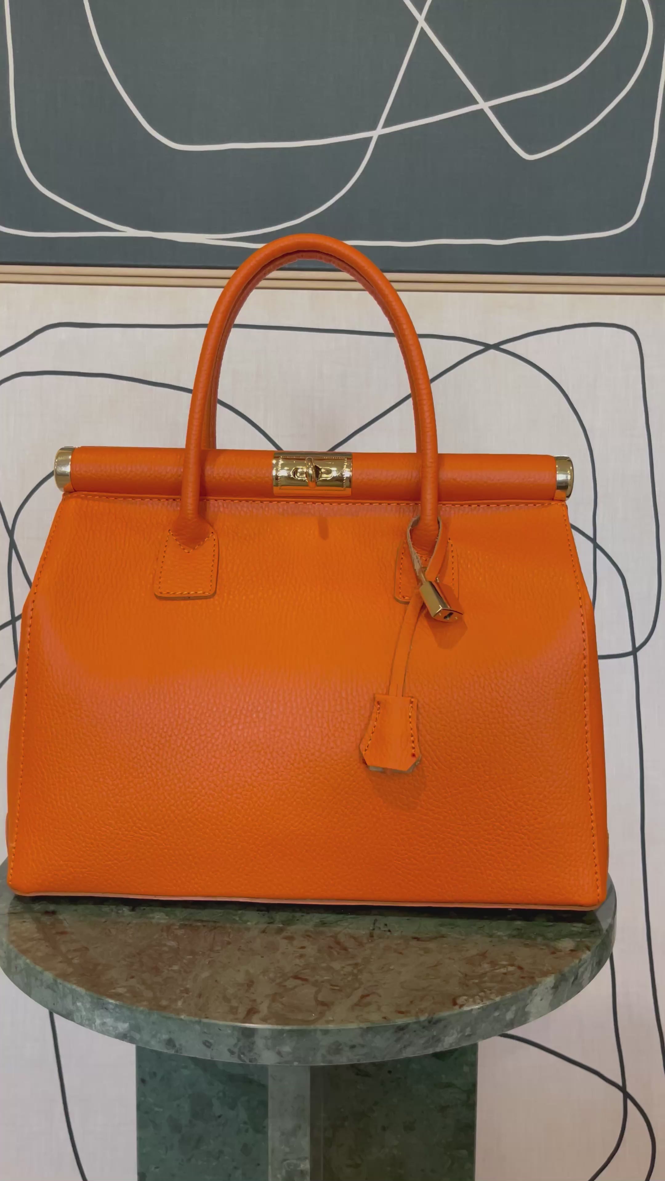 GOLDxTEAL gorgeous orange leather gold metal lock handbag.