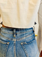 GOLDxTEAL stylish cropped white button up shirt. Modern asymmetrical button up shirt with  a raw hem line.