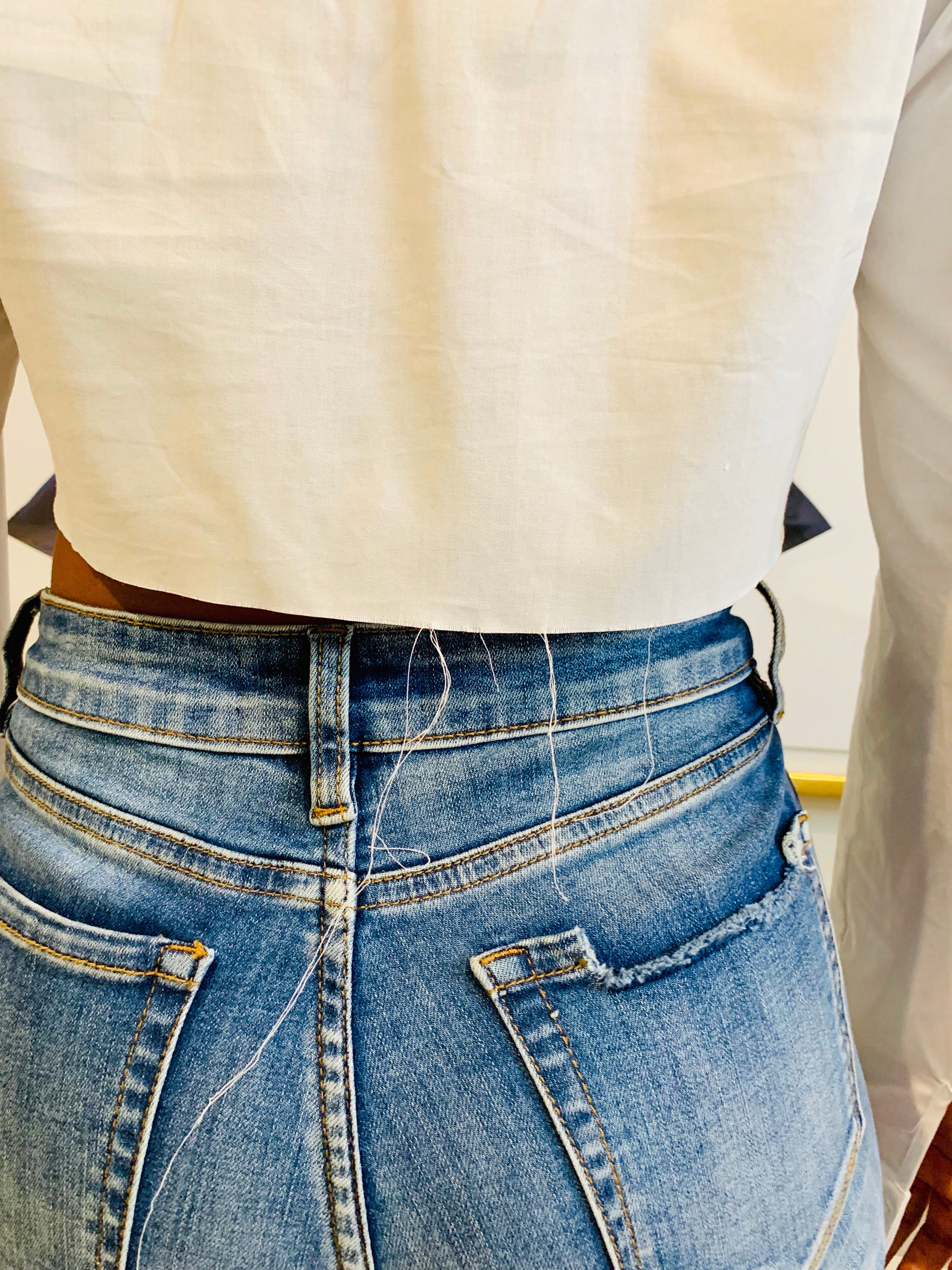 GOLDxTEAL stylish cropped white button up shirt. Modern asymmetrical button up shirt with  a raw hem line.