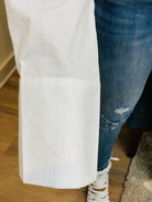 GOLDxTEAL stylish cropped white button up shirt. Modern asymmetrical button up shirt with  a raw hem line.