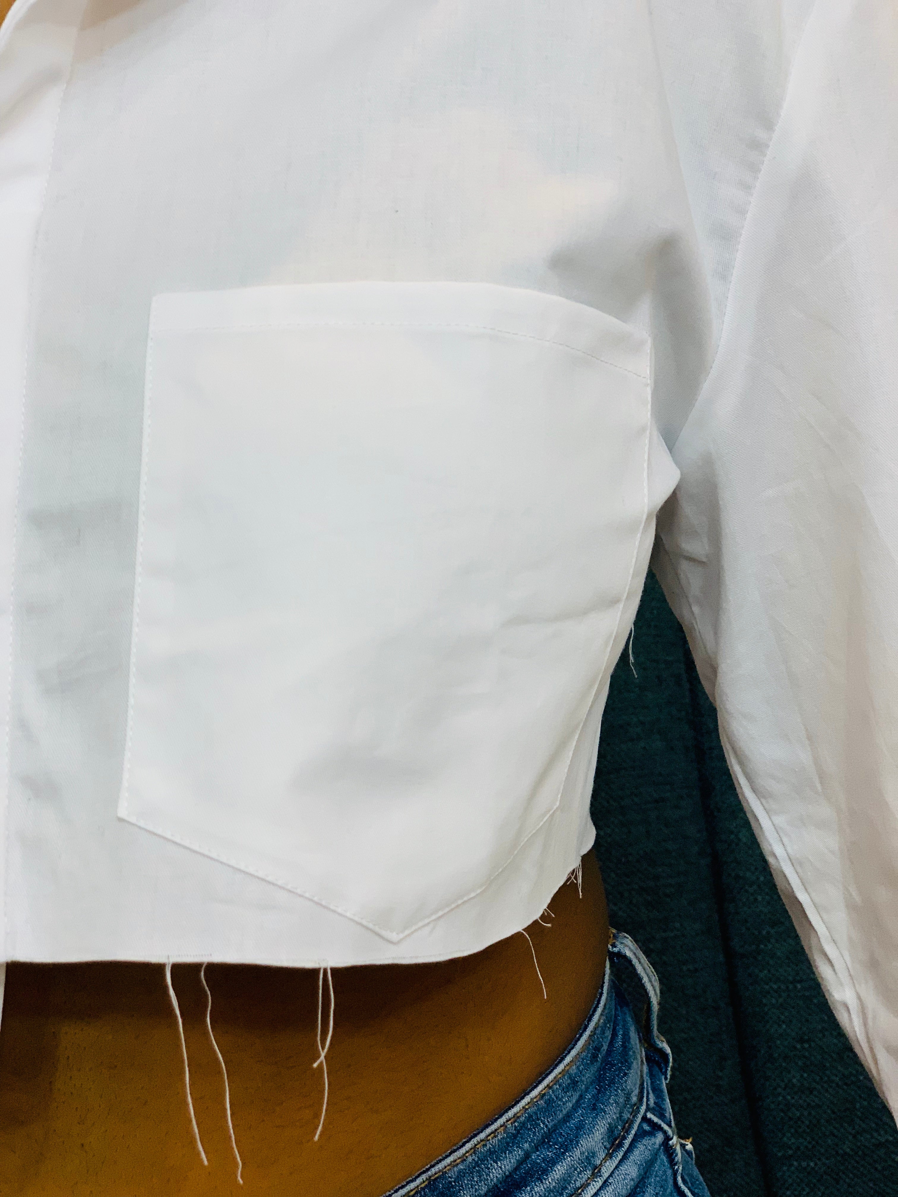 GOLDxTEAL stylish cropped white button up shirt. Modern asymmetrical button up shirt with  a raw hem line.