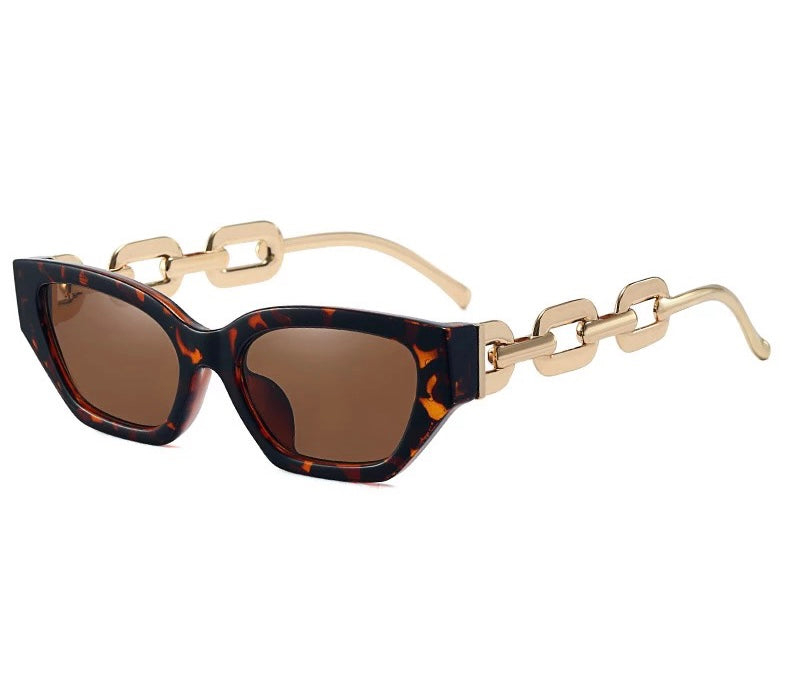 GOLDxTEAL tortoise cat eye sunglasses with metal chain arms.